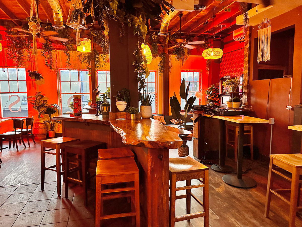 wooden bar with stools and tree decor